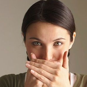 girl covering her mouth