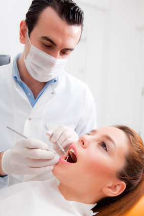 dentist cleaning a patient's teeth