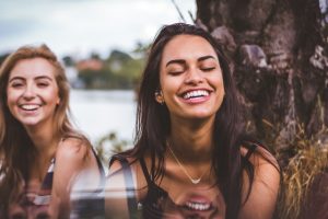 young women outdoors, smiling