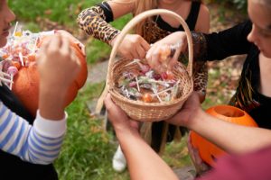 children getting candy from a wicker basket