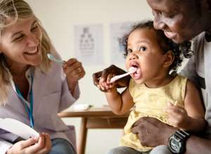 baby brushing at dentist