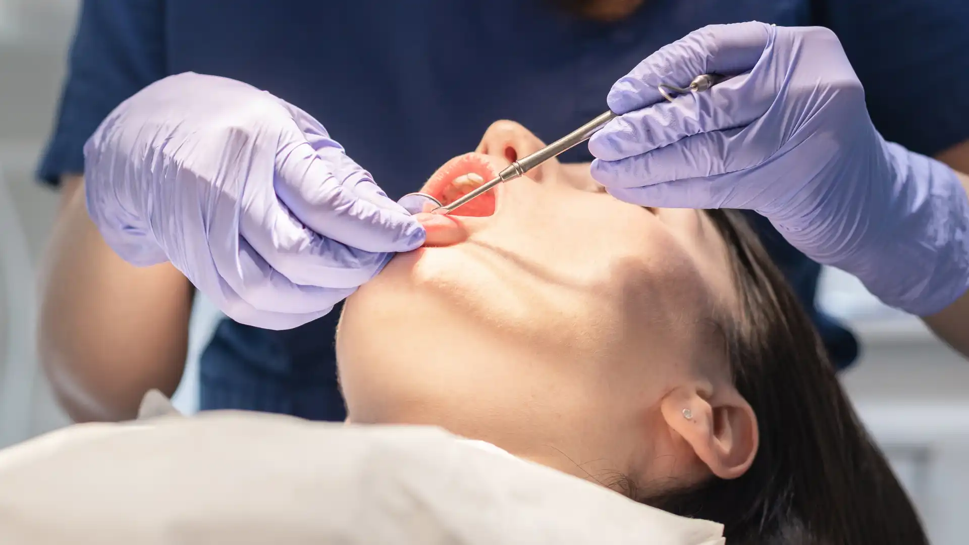 Dentist performing a dental procedure on a patient.