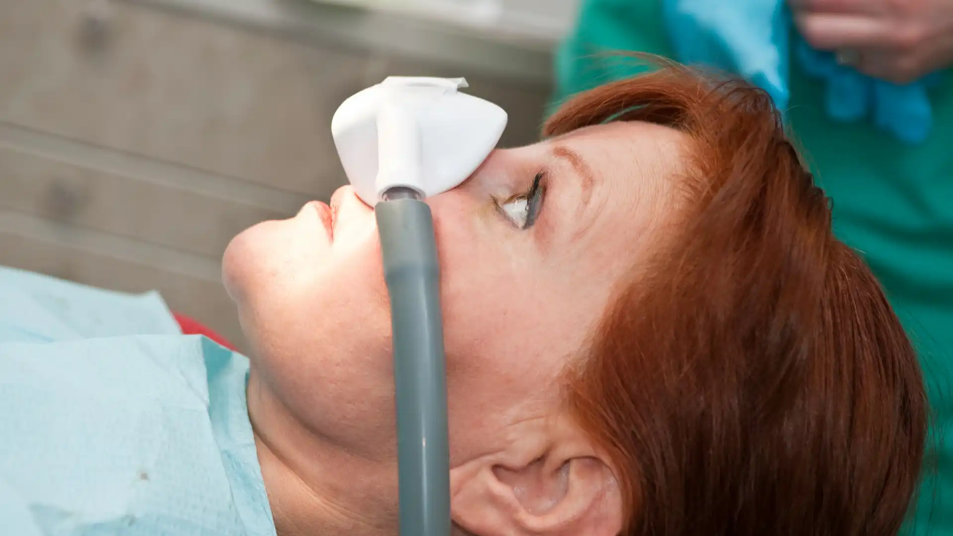 Patient receiving nitrous oxide sedation during a dental procedure.