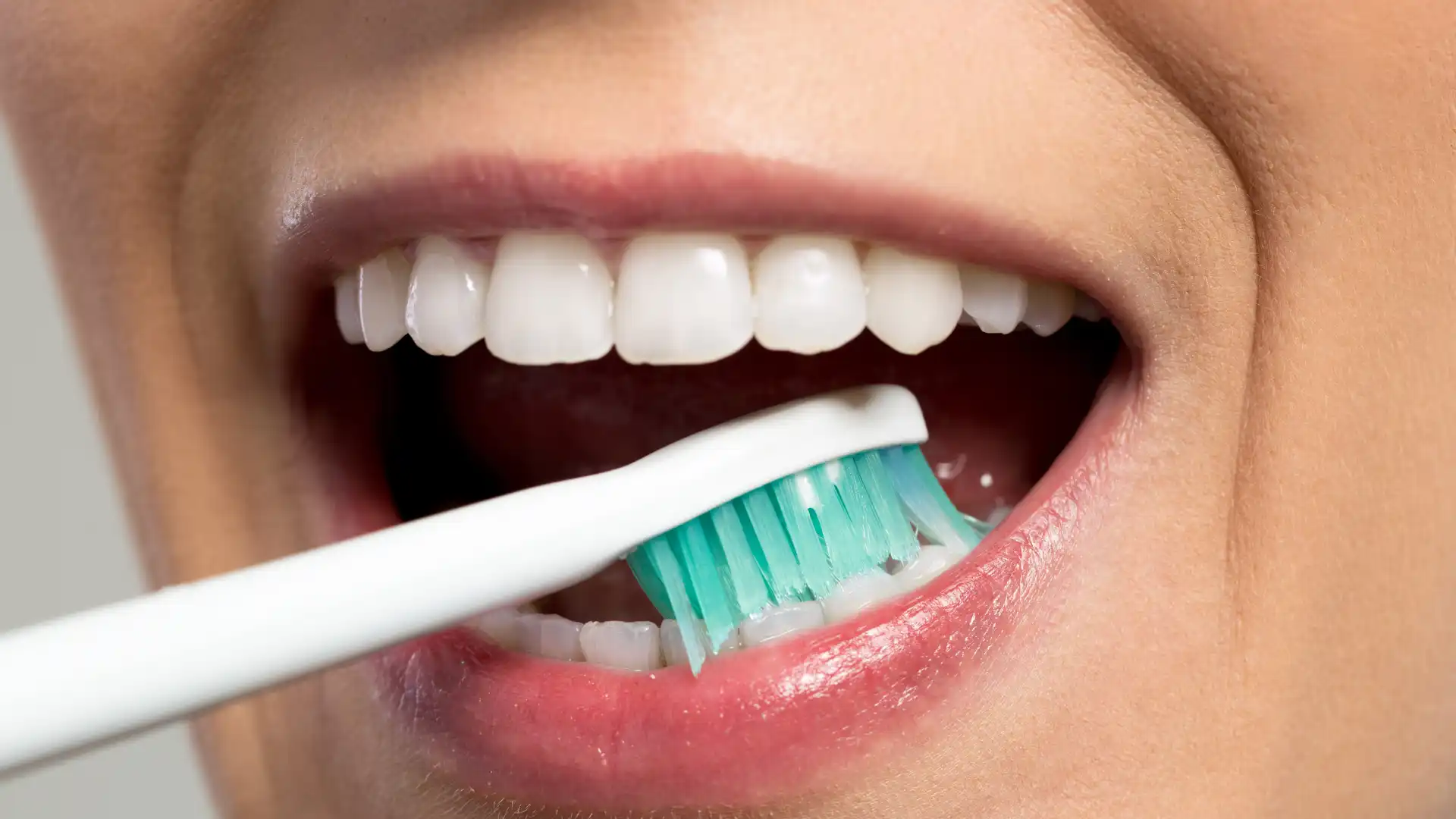 Close-up of teeth being brushed