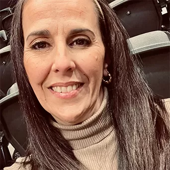 A woman with long hair wearing a turtle neck sweater, exuding a stylish and cozy appearance.